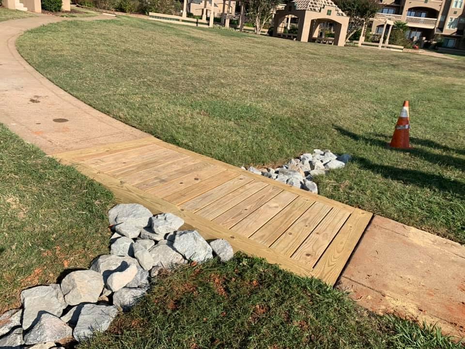 New wooden walkway section set in a lawn